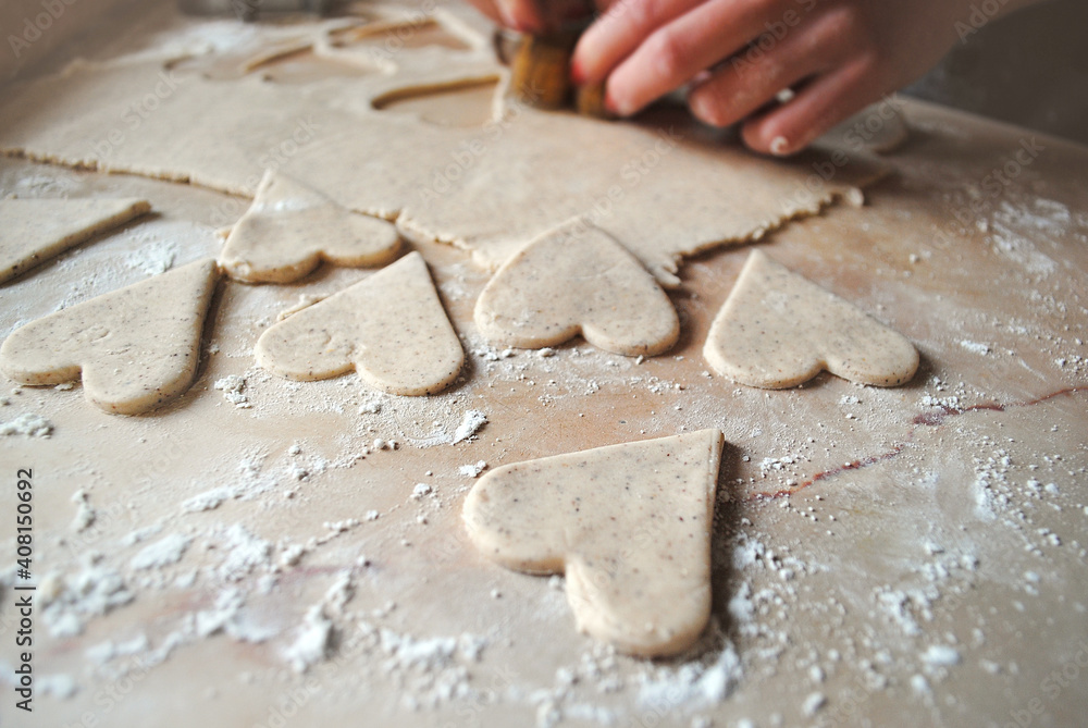 The girl prepares cookies in the shape of a heart.
Gluten-free rice flour biscuits. The girl prepares cookies in the shape of a heart.
Gluten-free rice flour biscuits.