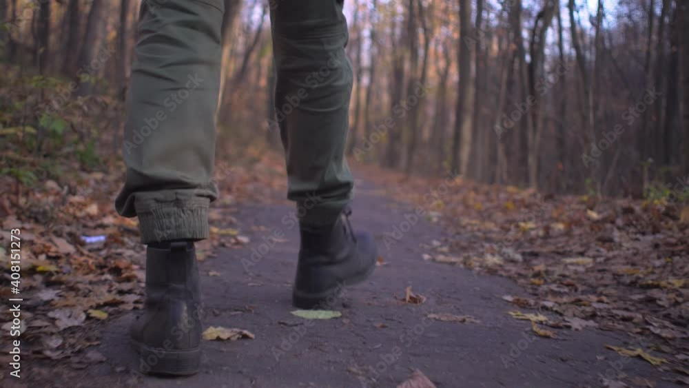 Male legs in military cargo trousers and soldier boots walks alone in forest park during covid pandemic coronavirus lockdown Male legs in military cargo trousers and soldier boots walks alone in forest park during covid pandemic coronavirus lockdown