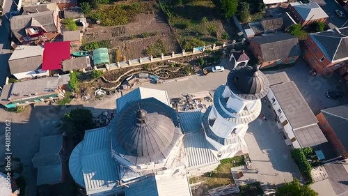 Aerial view of a christian cathedral with bell tower and domes. photo