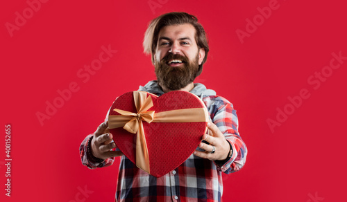 It is just unbelievable. handsome man with gift. romantic date. guy with long beard hold heart box © be free