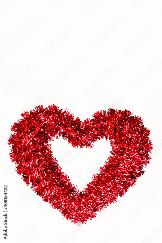 Tinsel heart with a white background vertical orientation and copy space Tinsel heart with a white background vertical orientation and copy space