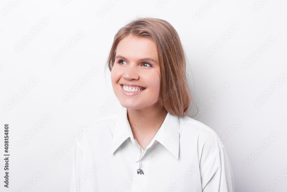 Photo of happy smiling young woman in casual looking aside. Photo of happy smiling young woman in casual looking aside.