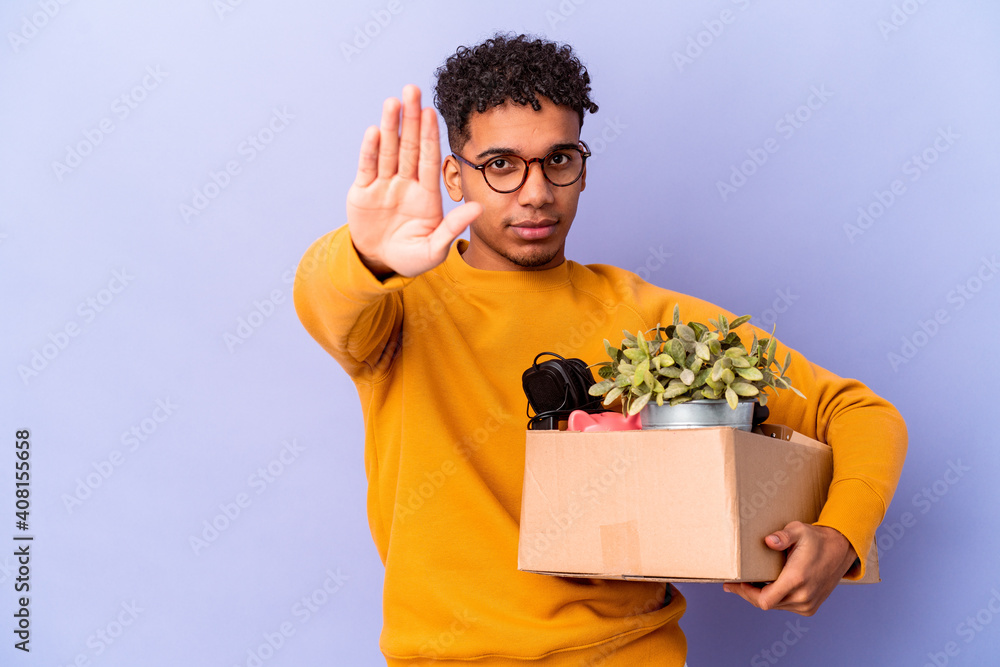 Young african american curly man isolated moving to a new home standing with outstretched hand showing stop sign, preventing you. Young african american curly man isolated moving to a new home standing with outstretched hand showing stop sign, preventing you.