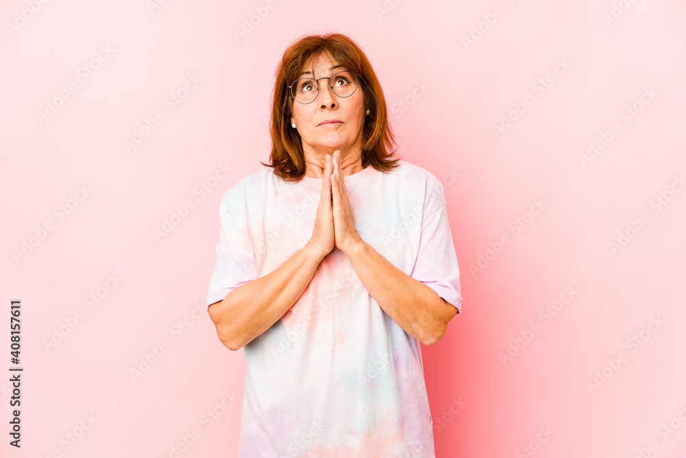 Senior caucasian woman isolated holding hands in pray near mouth, feels confident. Senior caucasian woman isolated holding hands in pray near mouth, feels confident.