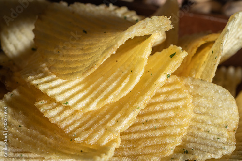 Corrugated chips with greens background photo