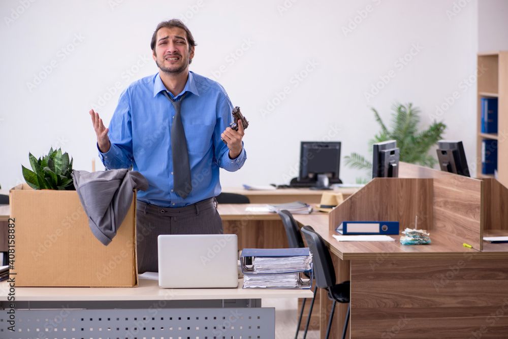 Young male employee being fired from his work Young male employee being fired from his work