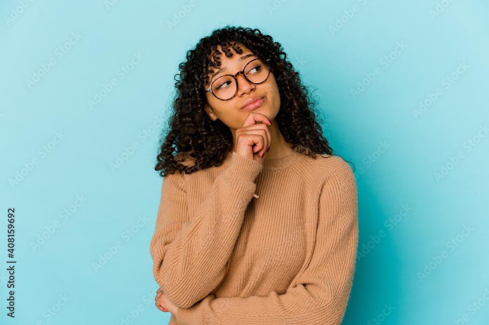Young african american afro woman isolated looking sideways with doubtful and skeptical expression. Young african american afro woman isolated looking sideways with doubtful and skeptical expression.