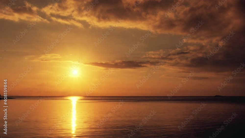 Sunset time above the ocean, water surface in slow motion at sunset time, nature background static shot Sunset time above the ocean, water surface in slow motion at sunset time, nature background static shot