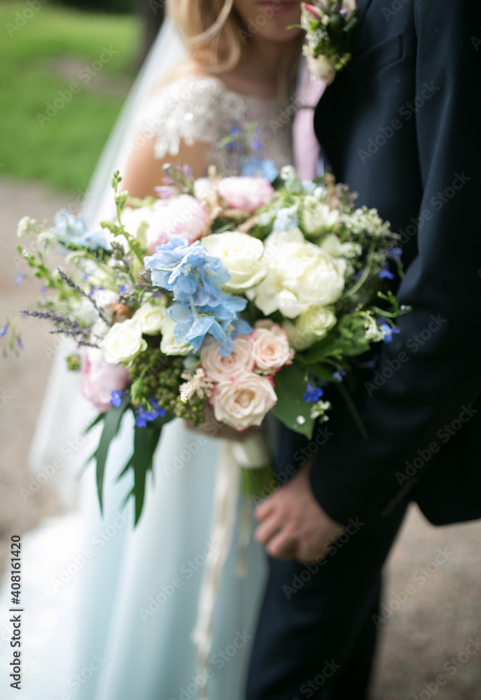 Wedding bouquet in the hands of the bride and groom.
