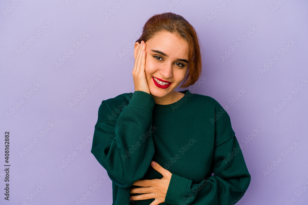 Young arab mixed race woman laughs happily and has fun keeping hands on stomach. Young arab mixed race woman laughs happily and has fun keeping hands on stomach.