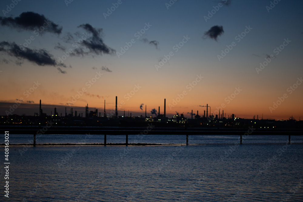 Oil refinery at dusk. Oil refinery energy production fossil fuels pollution environmental impact Oil refinery at dusk. Oil refinery energy production fossil fuels pollution environmental impact