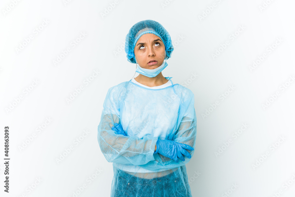 Young surgeon latin woman isolated on white background tired of a repetitive task. Young surgeon latin woman isolated on white background tired of a repetitive task.