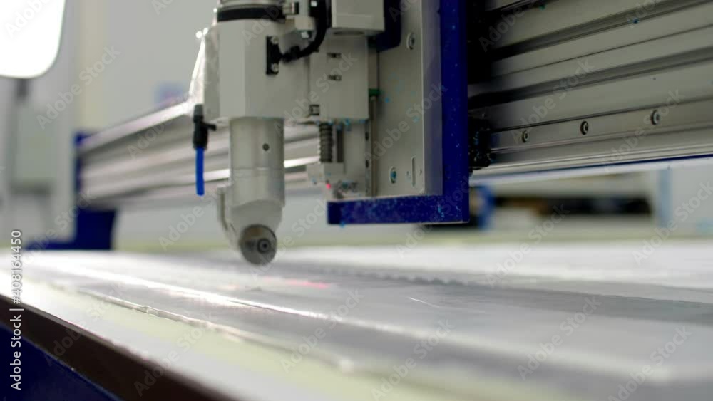 Cutting machine makes details for medical clothes on table Cutting machine makes details for medical clothes on table