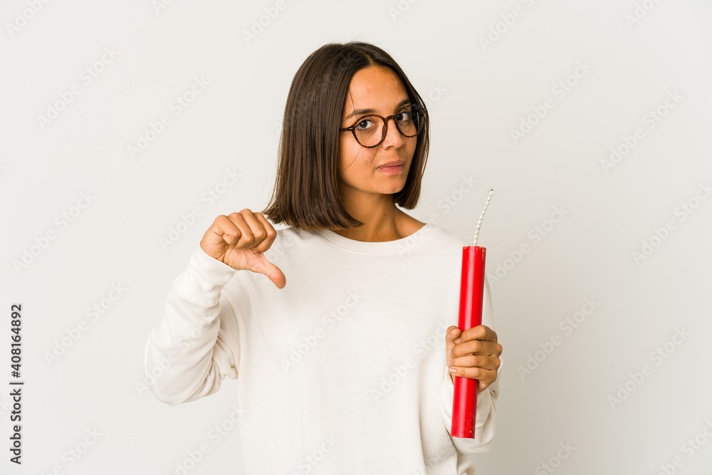 Young hispanic mixed race woman holding a dynamite showing a dislike gesture, thumbs down. Disagreement concept. Young hispanic mixed race woman holding a dynamite showing a dislike gesture, thumbs down. Disagreement concept.