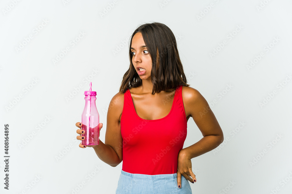 Young latin woman holding a milkshake isolated on white background Young latin woman holding a milkshake isolated on white background