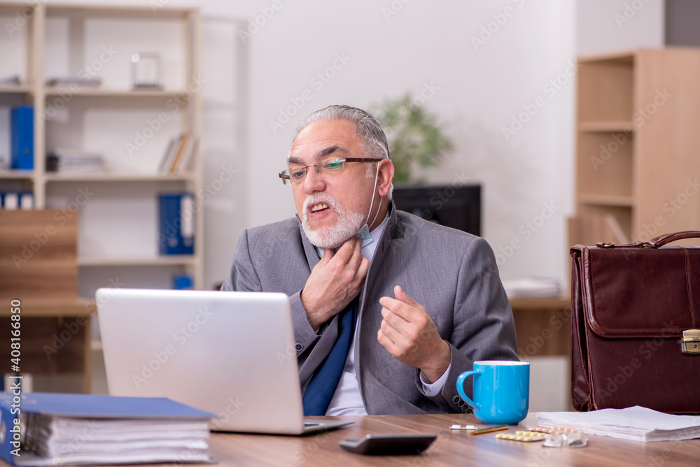 Coronavirus infected old businessman employee sitting in the off