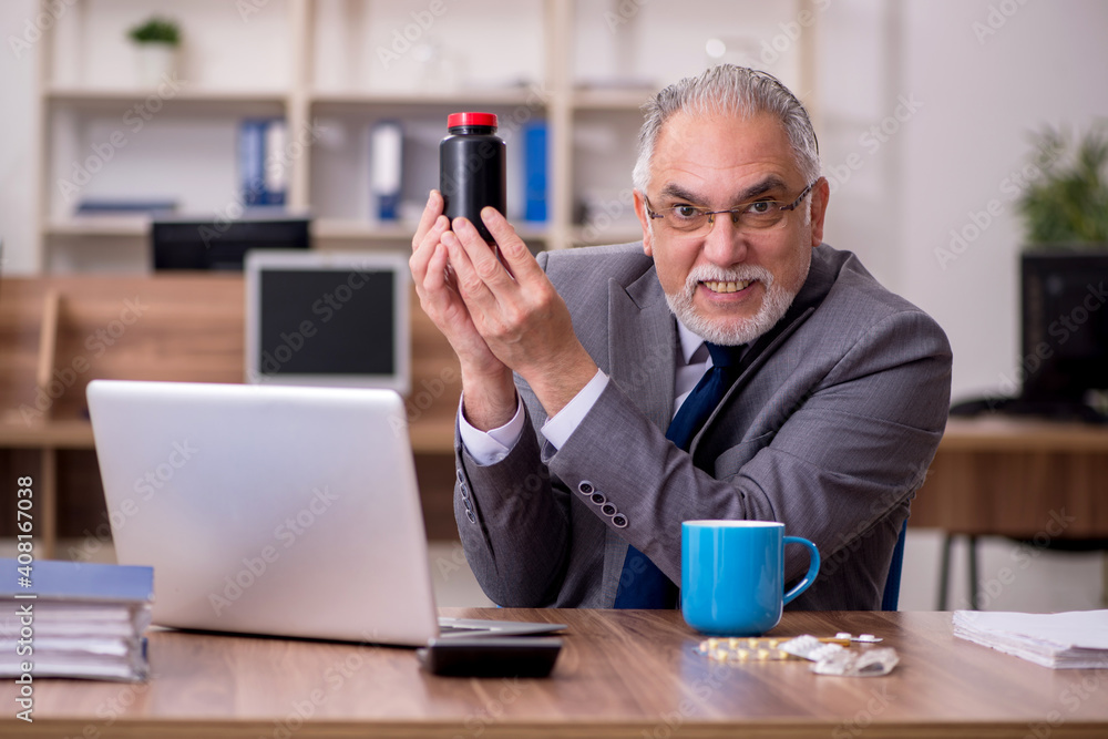 Coronavirus infected old businessman employee sitting in the off Coronavirus infected old businessman employee sitting in the off