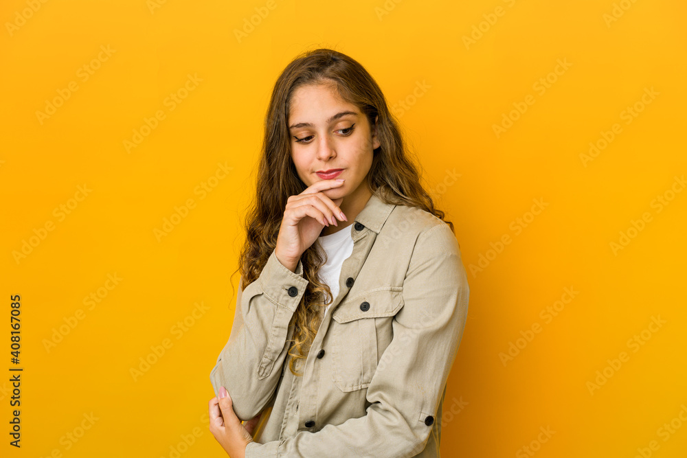 Young caucasian woman looking sideways with doubtful and skeptical expression. Young caucasian woman looking sideways with doubtful and skeptical expression.