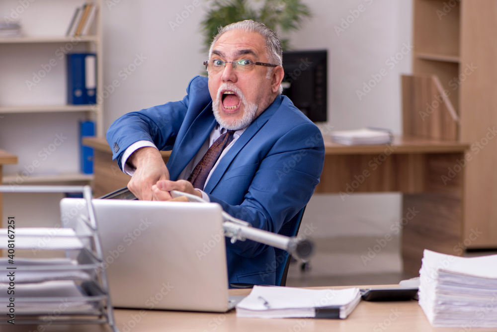 Old businessman employee after accident working in the office Old businessman employee after accident working in the office