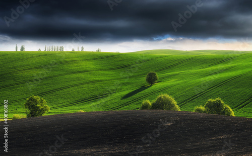 picturesque clouds over a hilly field. dramatic sky over rural landscape