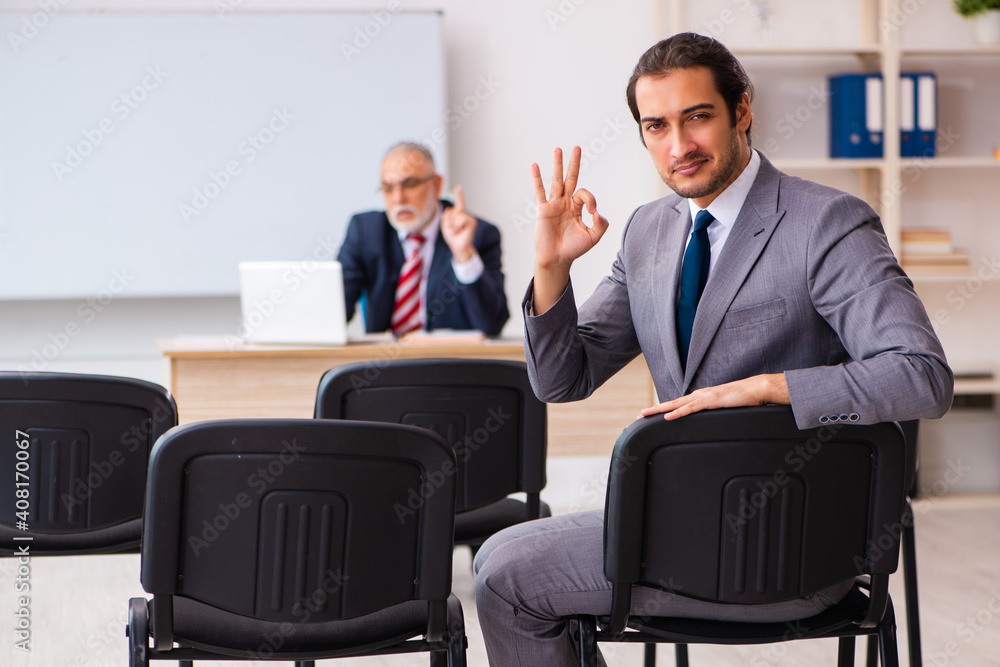 Two businessmen in the classroom in pandemic concept Two businessmen in the classroom in pandemic concept