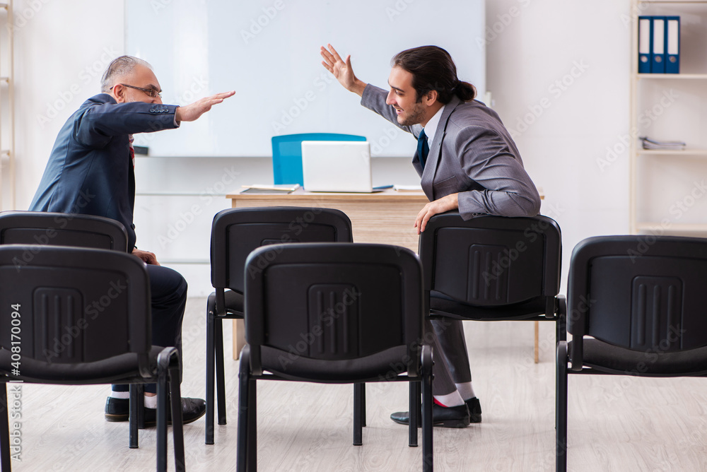 Two businessmen in the classroom in pandemic concept Two businessmen in the classroom in pandemic concept
