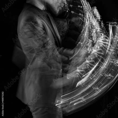 A stroboscopic image of a male saxophone player in motion against a black background