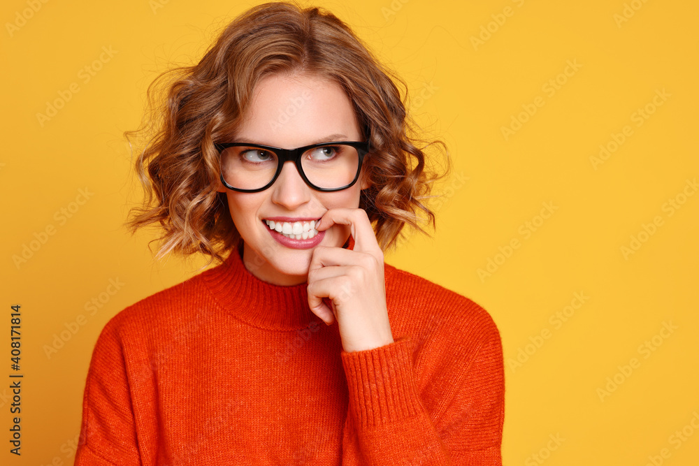 Dreamy young woman biting nail Dreamy young woman biting nail