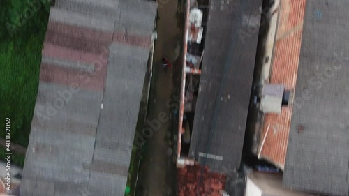 Black man running in the corridors of the favela slum