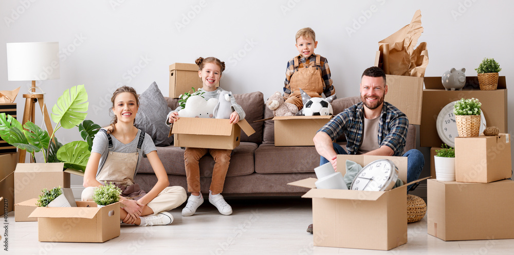 happy family mother father and children move to new apartment and look at the camera while unpacking the boxes happy family mother father and children move to new apartment and look at the camera while unpacking the boxes