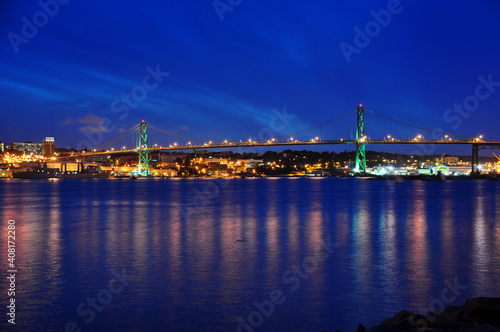 Angus L. Macdonald Bridge that connects Halifax to Dartmouth, Nova Scotia. Taken at night with reflections in water