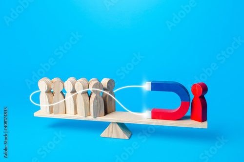 Red man with a magnet embraces and attracts people to his side. Recruiting, influencing. Political support. Leader and leadership. Attracting attention favoring yourself. Joining new member followers.
