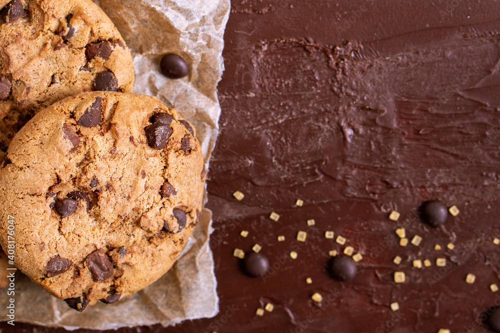Fototapeta premium dark chocolate chip cookie round gold concept Organic fresh bake homemade tasty sweet dessert piece of closeup on cookie on wooden table for holiday new year Christmas gift sugar sparkle