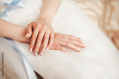 bride sits folded her armly dress. Wedding photo.