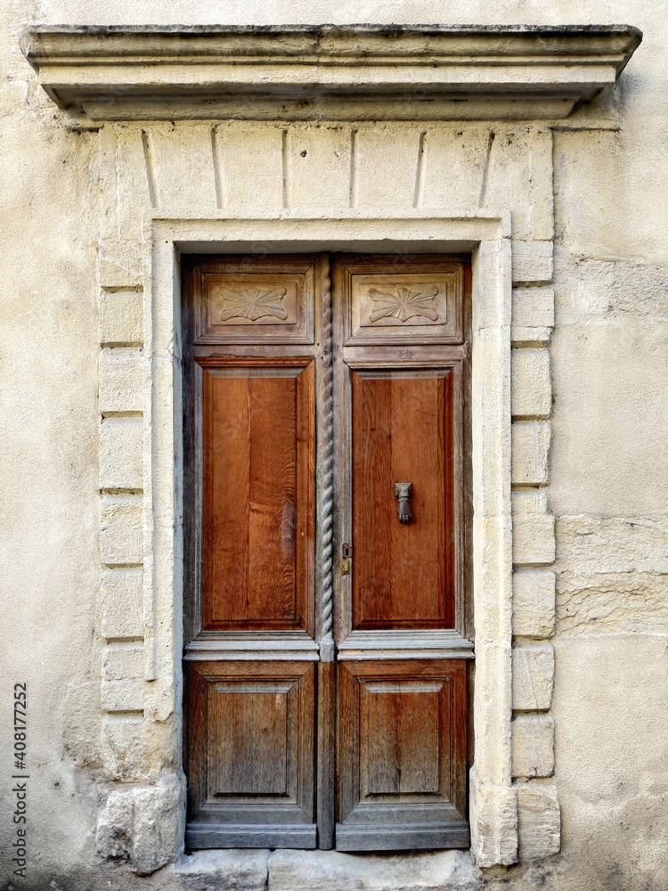 Wooden brown vintage door in the old stone building.