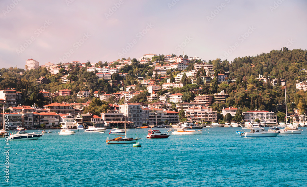 View on marine in Bosporus Strait with boats and ships before hilly residential blocks of Bebek neighborhood behind Cevdet Pasa street in Besiktas district of Istanbul