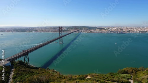 Wallpaper Mural Tagus river and large 25 April bridge panorama from above, time lapse shot. Cars race on highway, several boats sail by on water. Lisbon city seen at opposite bank of wide channel Torontodigital.ca