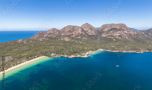 Stunning high angle aerial drone view of the famous Hazards mountain range, Richardsons Beach and Honeymoon Bay, part of Freycinet Peninsula and National Park in East Coast Tasmania, Australia.