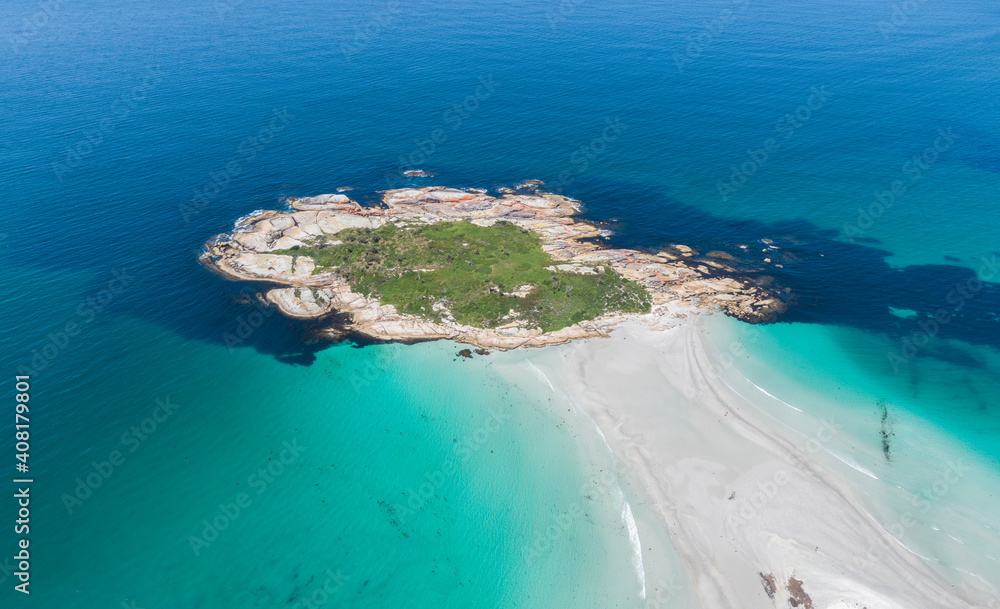 Stunning aerial high angle drone view of Diamond Island (Cod Rock), connected to the main land through a sand bank north of the beach resort village Bicheno on the east coast of Tasmania, Australia.
