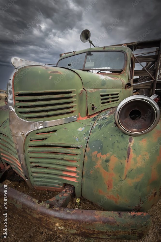 Fototapeta premium Old abandoned rusty truck with cloudy sky background