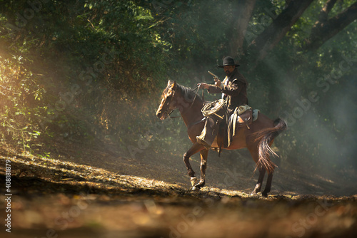 Cowboy riding a horse carrying a gun