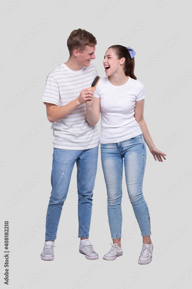 Couple Singing to HairBrush Isolated. Couple Having Fun Couple Singing to HairBrush Isolated. Couple Having Fun