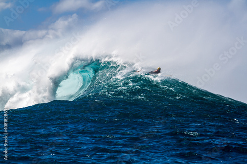 A Surfer riding over a wave in Hawaii