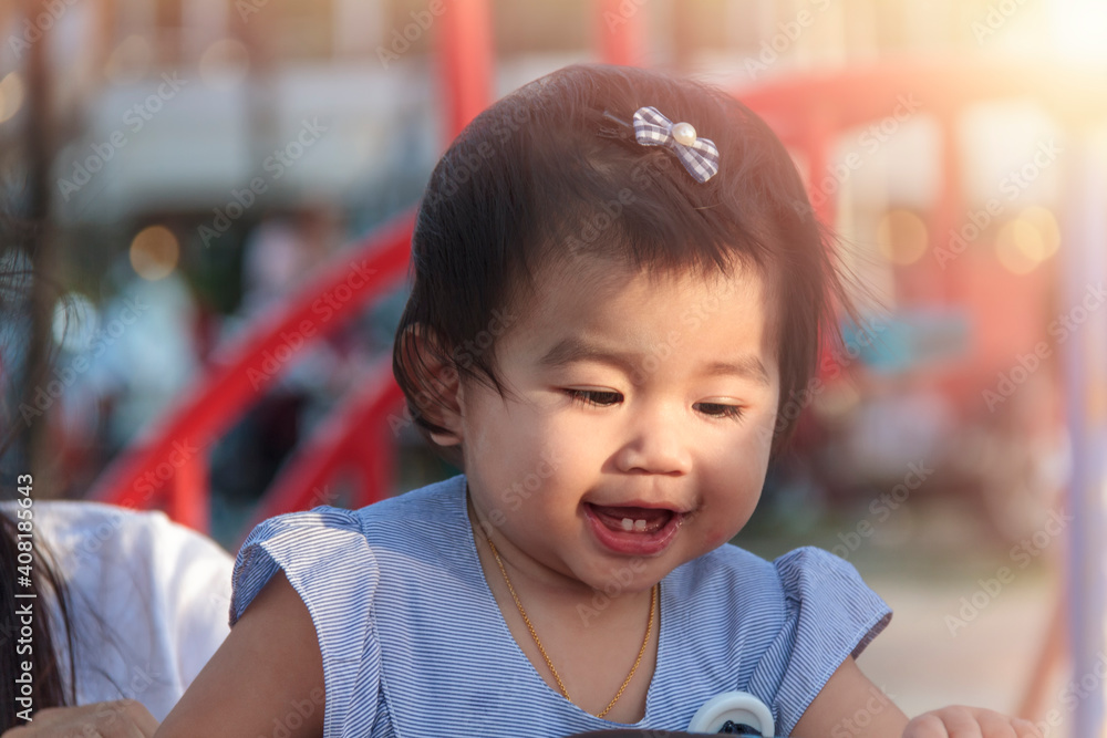 Portrait of smiling happy little girl enjoy with playground outdoor. Child playing on outdoor playground. Asian little girl play at outdoor playground. Portrait of smiling happy little girl enjoy with playground outdoor. Child playing on outdoor playground. Asian little girl play at outdoor playground.