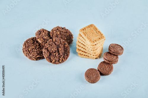 Chocolate and oatmeal cookies on blue background