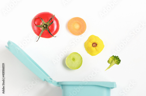 Food waste and trash can on white background close-up