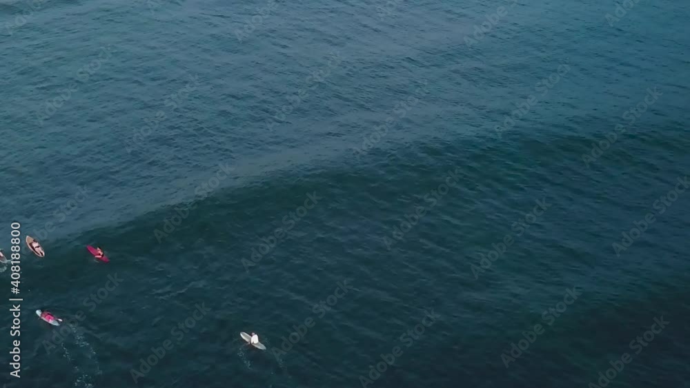 Drone aerial waves sunset surfers on ocean Drone aerial waves sunset surfers on ocean