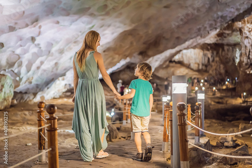 Mom and son tourists in Hang Sung Sot Grotto Cave of Surprises, Halong Bay, Vietnam. Traveling with children concept. Tourism after coronavirus