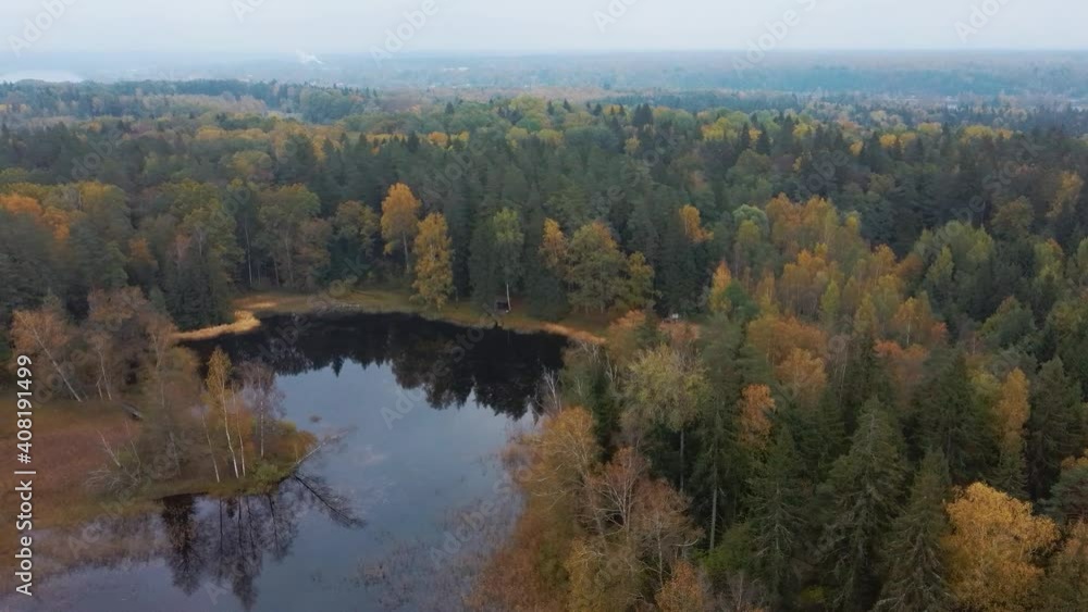 Aerial View of Green Pine and Spruce Conifer Treetops Forest and Kalnmuiza lake in Latvia. Colorful Forest Woodland in the Autumn. Yellow Leaves on Tree Crowns in Fall. 4k Shot.
Camera moves Sideward Aerial View of Green Pine and Spruce Conifer Treetops Forest and Kalnmuiza lake in Latvia. Colorful Forest Woodland in the Autumn. Yellow Leaves on Tree Crowns in Fall. 4k Shot.
Camera moves Sideward