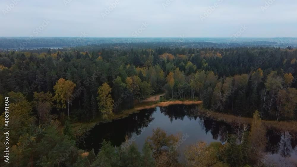 Aerial View of Green Pine and Spruce Conifer Treetops Forest and Kalnmuiza lake in Latvia. Colorful Forest Woodland in the Autumn. Yellow Leaves on Tree Crowns in Fall. 4k Video.
Camera moves Forward Aerial View of Green Pine and Spruce Conifer Treetops Forest and Kalnmuiza lake in Latvia. Colorful Forest Woodland in the Autumn. Yellow Leaves on Tree Crowns in Fall. 4k Video.
Camera moves Forward